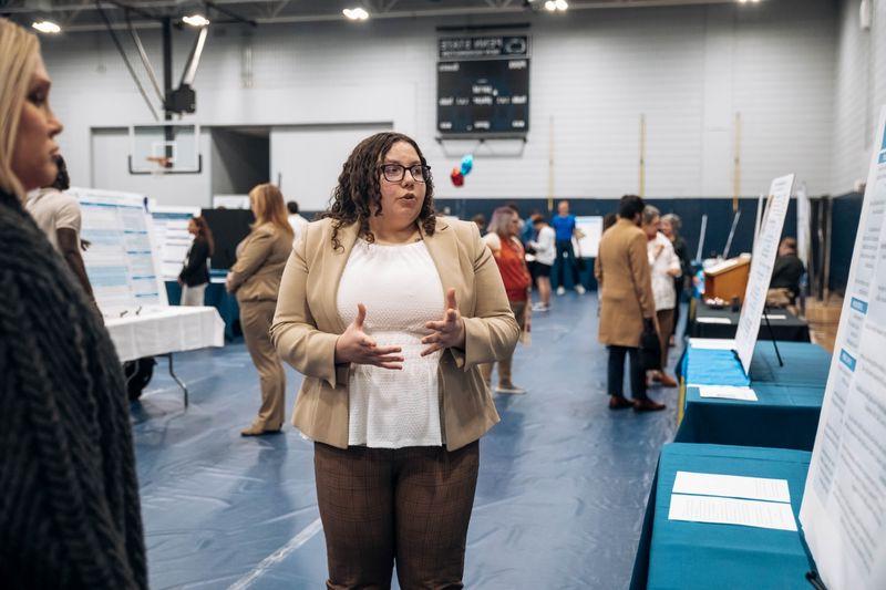 Student stands at research fair